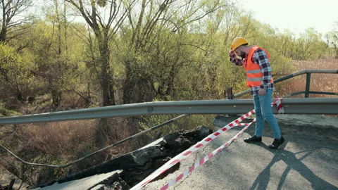 Destruction of canvas, collapse of bridge structure. Engineer in hardhat audit Stock Footage 153720384