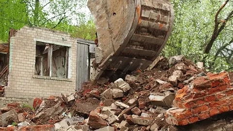 Destruction of an old building, an excavator breaks an old house. Deconstruct Stock Footage 196473735
