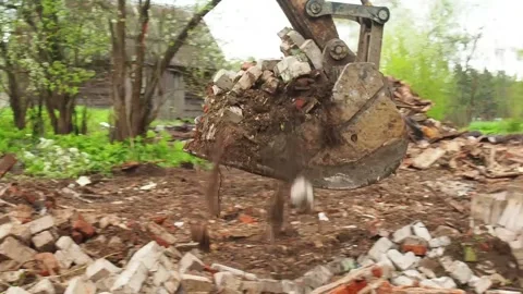 Destruction of an old building, an excavator breaks an old house. Deconstruct Stock Footage 196473779