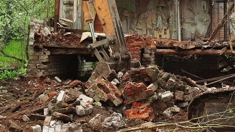 Destruction of an old building, an excavator breaks an old house. Deconstruct Stock Footage 196473836