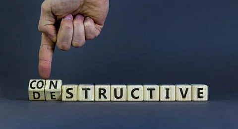 Destructive or constructive symbol. Businessman turns cubes and changes the c Stock Photos