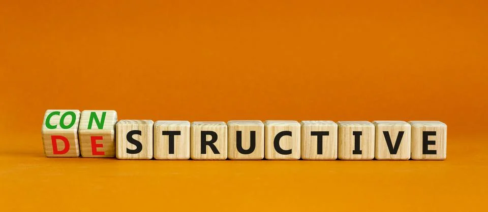Destructive or constructive symbol. Turned wooden cubes and changed the conce Stock Photos