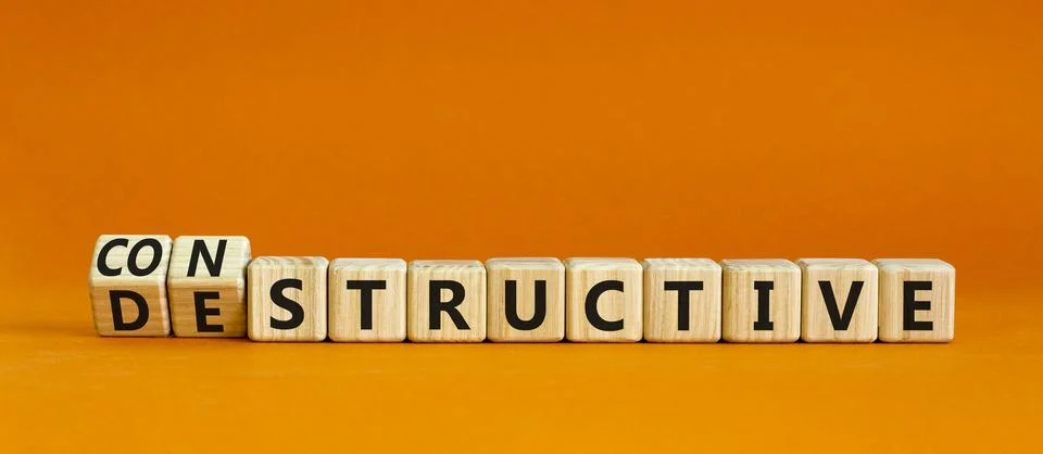 Destructive or constructive symbol. Turned wooden cubes and changed the conce Stock Photos