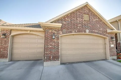 Detached double garage exterior with bricks and concrete driveway Stock Photos