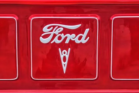 Detail of 1940 F100 Ford truck logo badge on a red tailgate.  Stock Photos