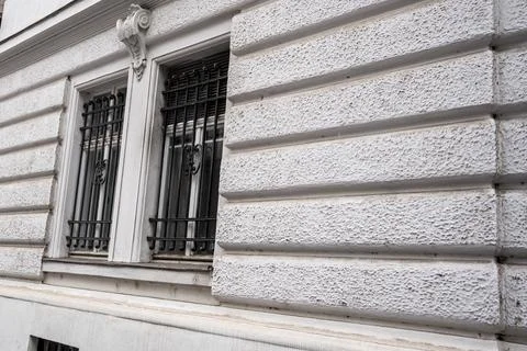 Detail of an architectural structure featuring two barred windows with intricate Stock Photos