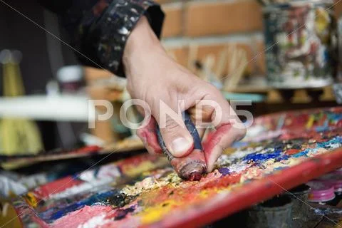 Detail of an artist mixing paint Stock Photos