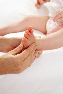 Detail baby having foot massage Stock Photos