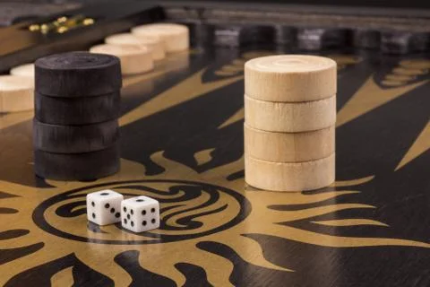 Detail of a backgammon game with two dice on black. Dice on backgammon board  Stock Photos