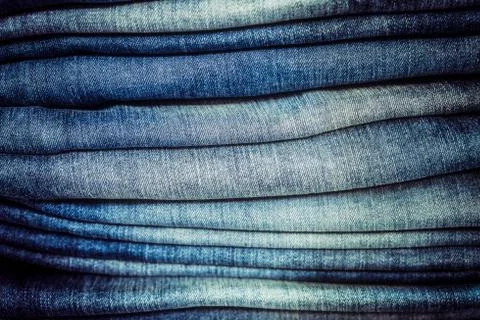 Detail of blue jeans stack with selective focus Stock Photos
