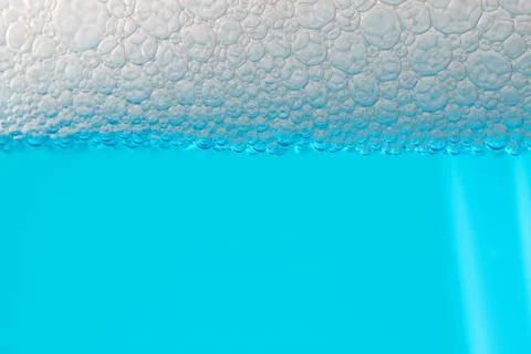 Detail bubbles in blue liquid. Stock Photos