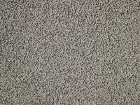 Detail of bumpy concrete wall painted in gray color Stock Photos