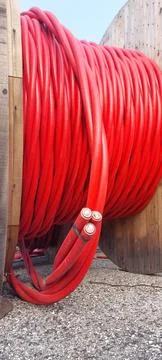 Detail of cable drum also called Electrical conductor reel with red cables .. Stock-Fotos