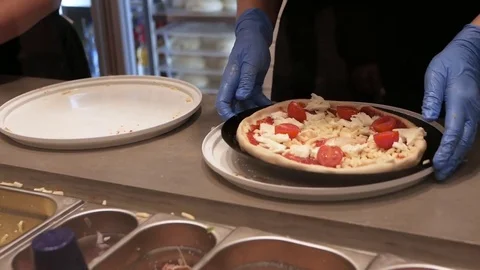 Detail Chefs hands in process of preparing pizza Stock Footage 83324072