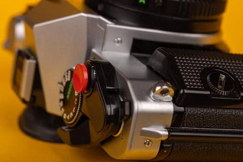 Detail of a classic camera lying flat, showcasing its red shutter button ag.. Stock Photos