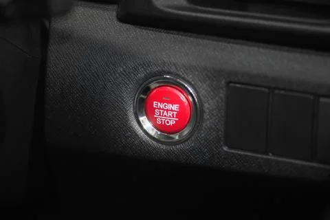 Detail close up of red engine start stop car button in modern car. Stock Photos