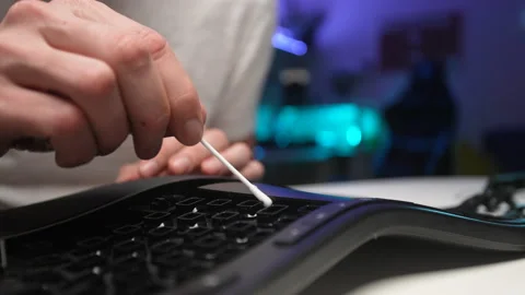 Detail close-up of unrecognizable man cleaning dirty disassembled black keyboard Stock Footage 238977461