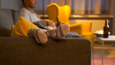 Detail of cute socks of girlfriend while watching TV together in living room. Video stock 119303205