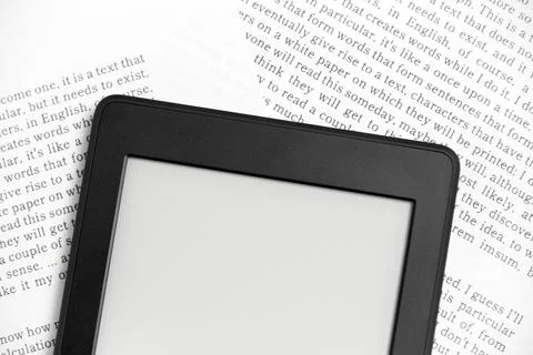 Detail of an electronic reader off on sheets of paper with text printed Stock Photos