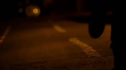 Detail of feet of  man running alone in the street during the night v Stock Footage