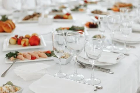 Detail of a festive table setup showing elegant wine glasses alongside plates Stock Photos