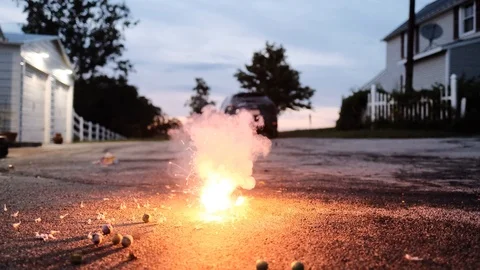 Detail of firework burning in backyard at twilight. Static. Blurry. Slow Stock Footage 112147058