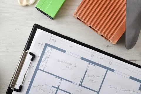 Detail with folder with plans and construction elements around Stock Photos