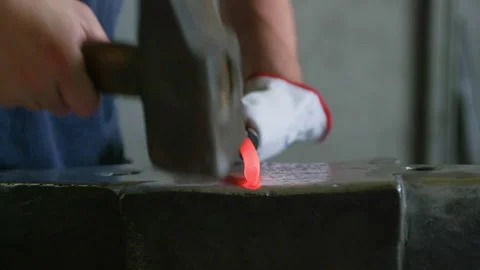Detail Front Shot of Blacksmith Hammering Hot Metal on Anvil Stock Footage 313849896