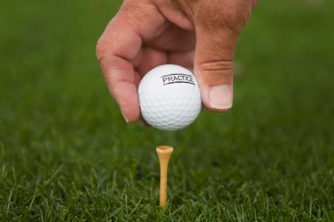 Detail of a golfer placing a golf ball on a tee Stock Photos