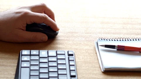 Detail of a hand with a computer mouse on an office table Stock Footage 129555919
