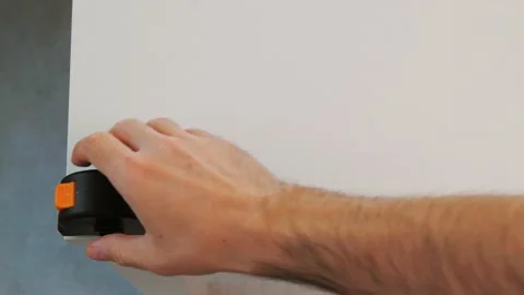 Detail of a hand measuring with a meter tool on a white background Stock-Footage 131020102