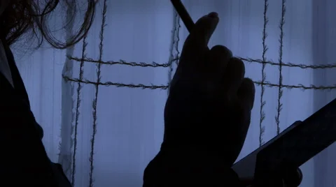 Detail of the hand of a woman writing a note with a pen, in a dark room Stock Footage 61767553