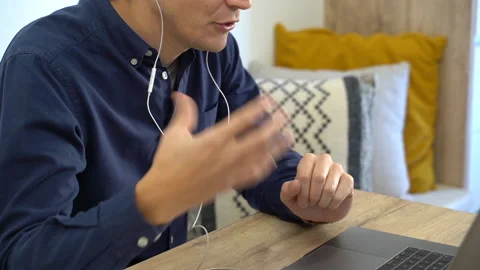 Detail of the hands of a man gesturing in front of a computer. Video stock 145434432