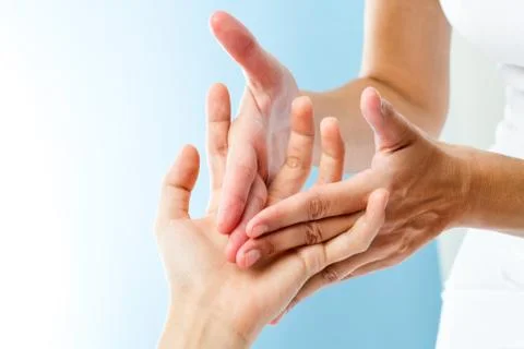 Detail of hands massaging hand. Stock Photos