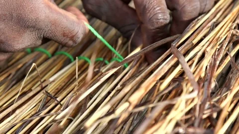 Detail of hands that weave the straw to make a thatched roof. About crafts Stock Footage 71327973