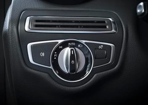 Detail of the headlight button in a car. Stock Photos