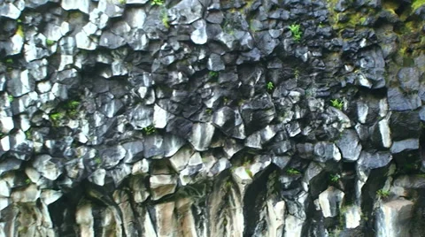 Detail on hexagonal volcanic basalt rock formations, zoom out Stock Footage 38020946