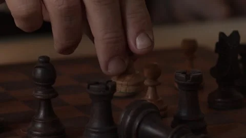 Detail of human hands playing chess and the pawn knocking down the king Stock Footage 264126216