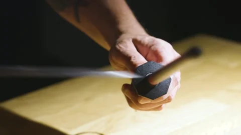 Detail image of man sharpening knife at dark kitchen Stock Footage 149009725