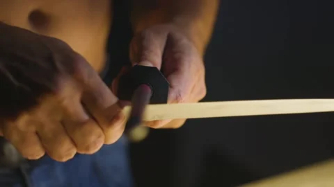 Detail image of man sharpening knife at dark kitchen Stock Footage 149009746