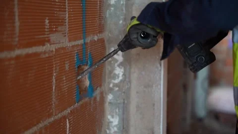 Detail of a jackhammer drilling a wall in the construction of a house for e.. Video stock 242005193
