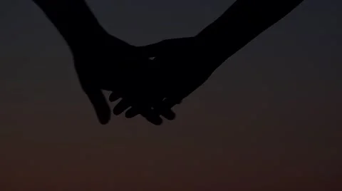 Detail of joining hands, dark background  Stock Footage 41785315