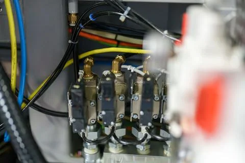 Detail of machine components in a workshop with various wires and tubes con.. Stock Photos