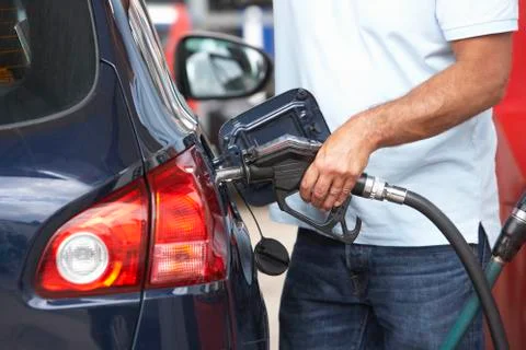 Detail Of Male Motorist Filling Car With Diesel At Petrol Station Stock Photos