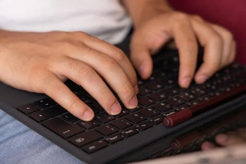 Detail of man hands using keyboard for tablet writing report Stock Photos