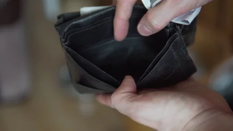 Detail Of Man Looking Through Wallet Empty Of Cash, No Money 4K Stock Footage 107627384