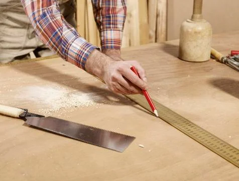 Detail of man marking piece of timber using pencil and ruler Stock Photos