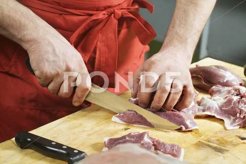 Detail of a man slicing meat Stock Photos