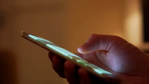 Detail of a Man Using Touchscreen Scrolling on a Modern Curved Edge Phone Stock Footage 83686631