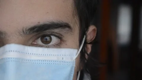 Detail of man's eye looking at camera and sides while put on a medical face mask Stock-Footage 146334184